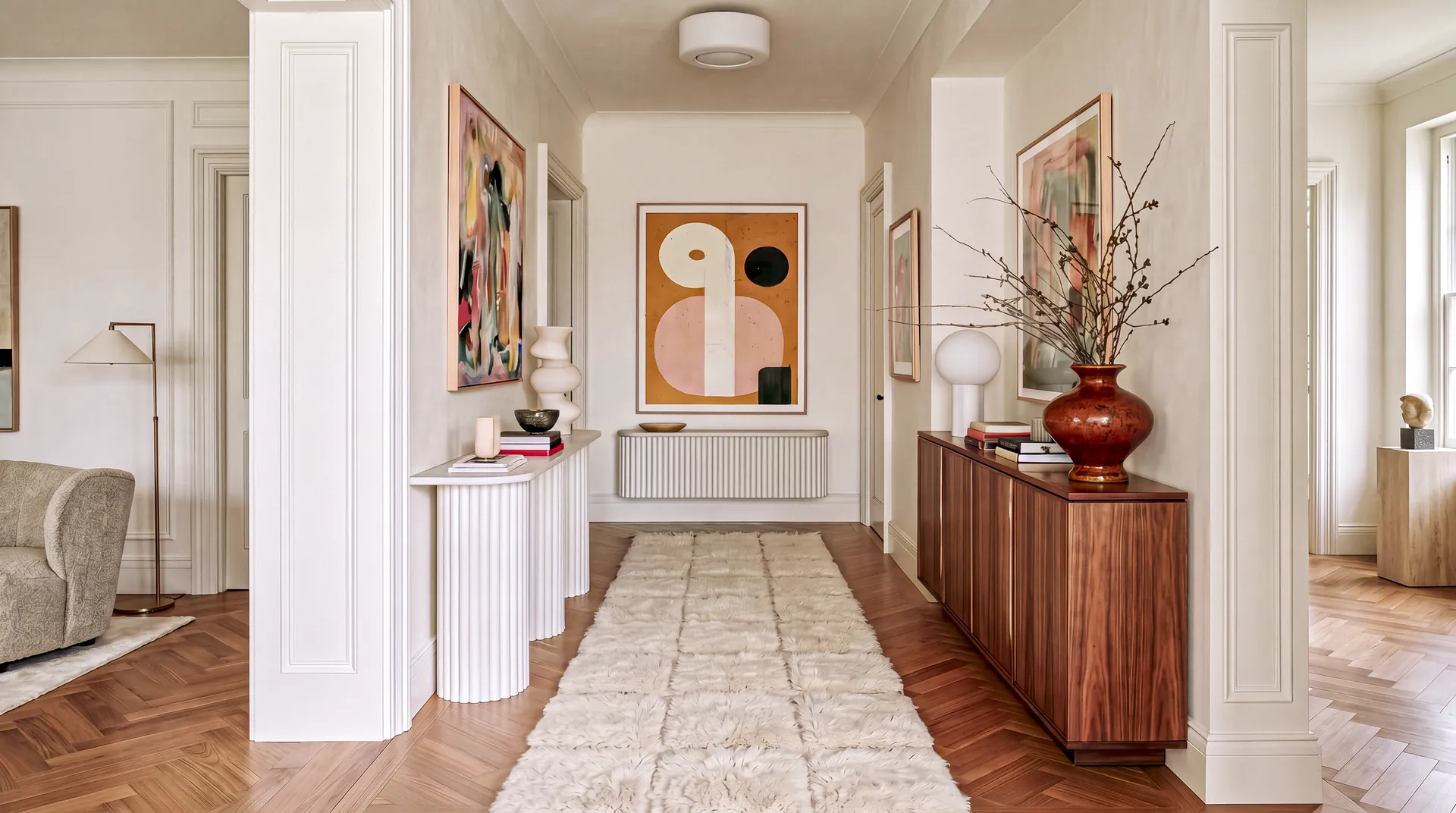 Tadla Ivory hand-knotted Beni Mrirt minimalist runner with raised shag squares in a white hallway with a walnut sideboard