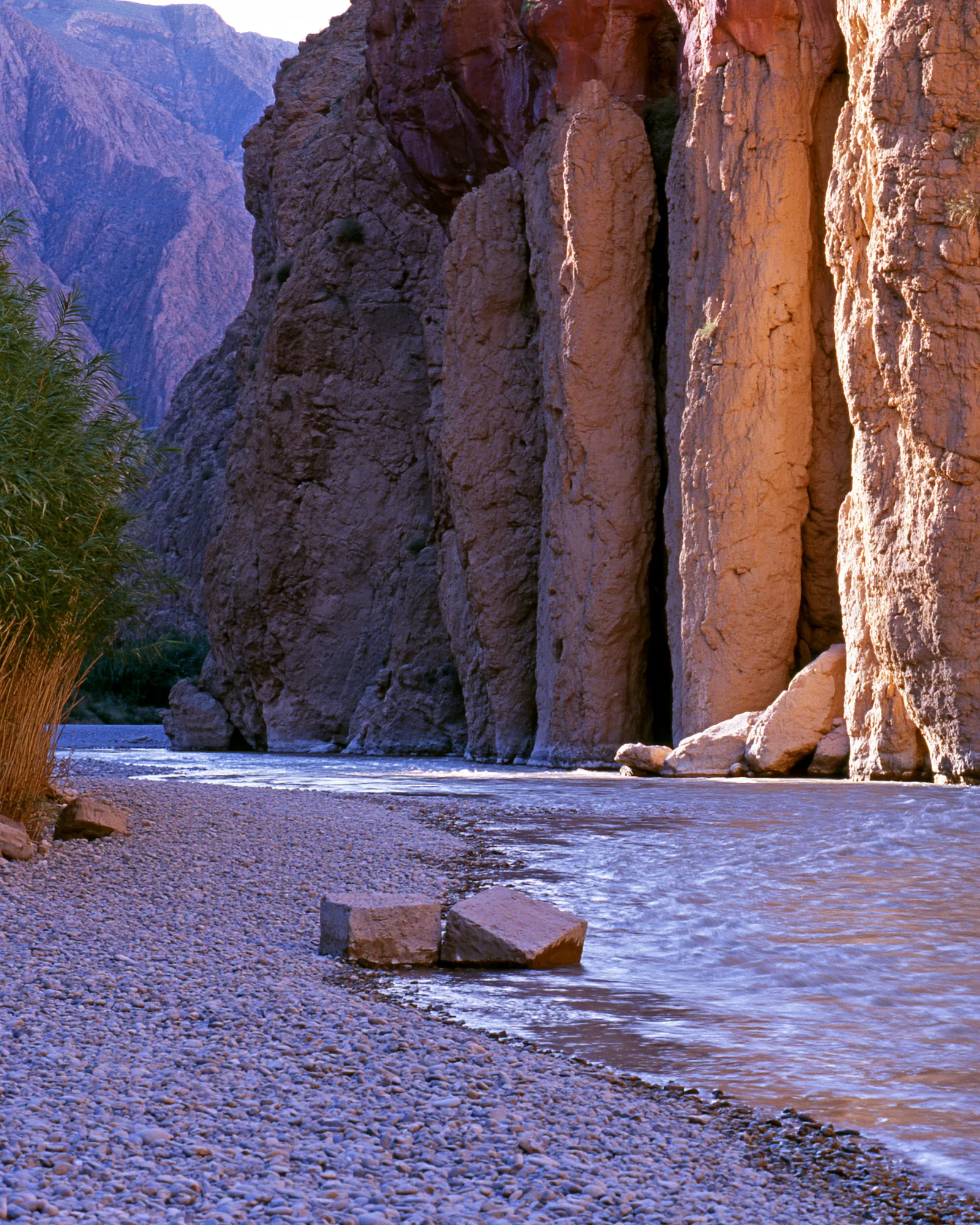 Coral rock columns above a river bed in a gorge, the inspiration for the Kasbah Coral & Burgundy rug