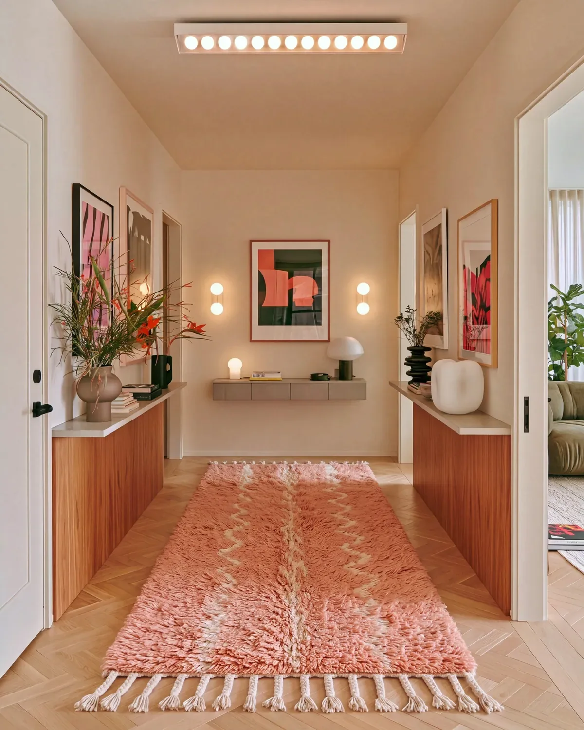 Abrid Dusty Rose hand-knotted Moroccan runner along a hallway between wood console tables