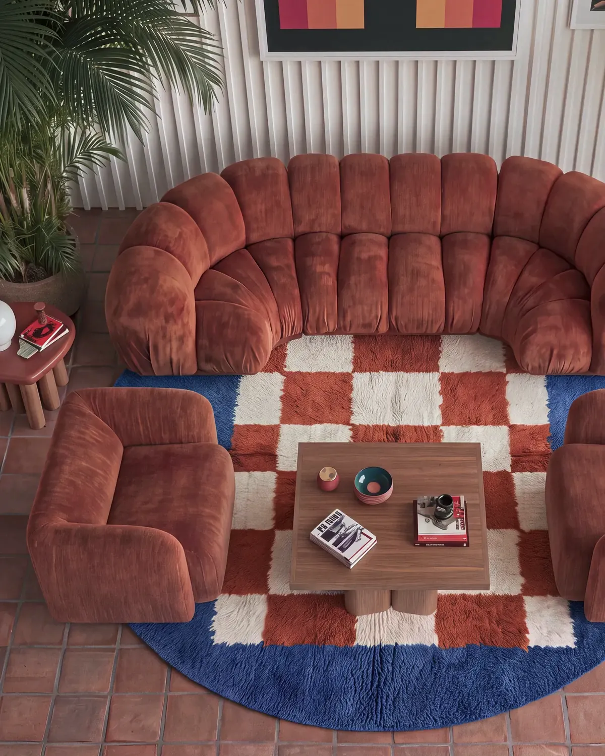 Afrag Cobalt & Rust hand-knotted Moroccan rug, round, in a living room beside a rust velvet sofa