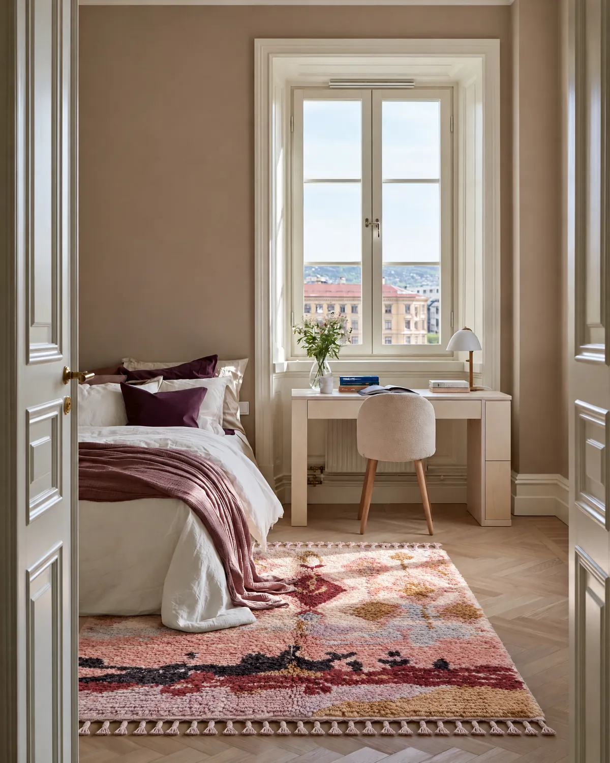 Louz Blush & Mustard hand-knotted Moroccan rug beside a white bed with plum pillows in a taupe teen room with a cream desk