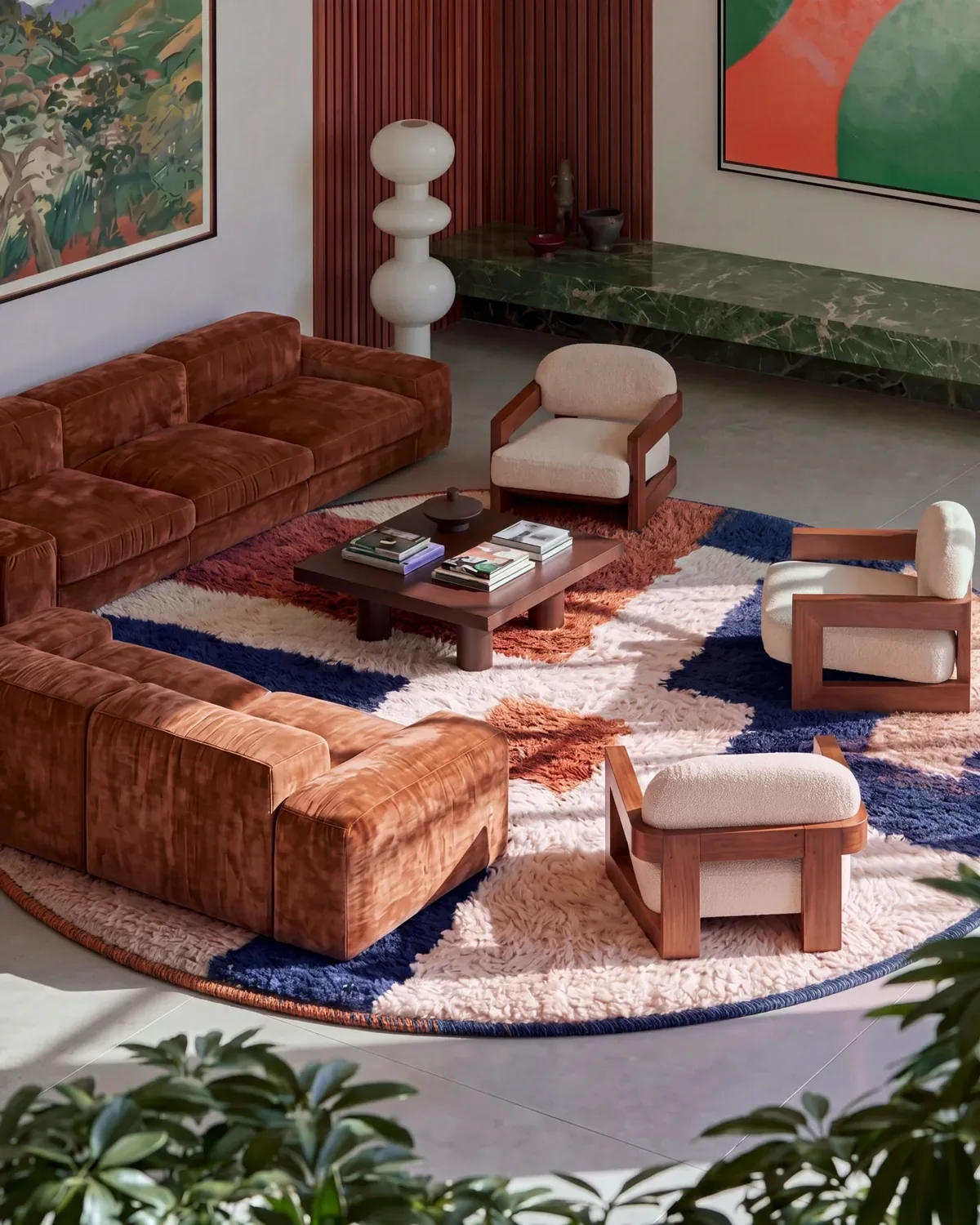 Darja Navy & Burnt Orange hand-knotted Moroccan rug, round, in a living room beside a brown velvet sectional