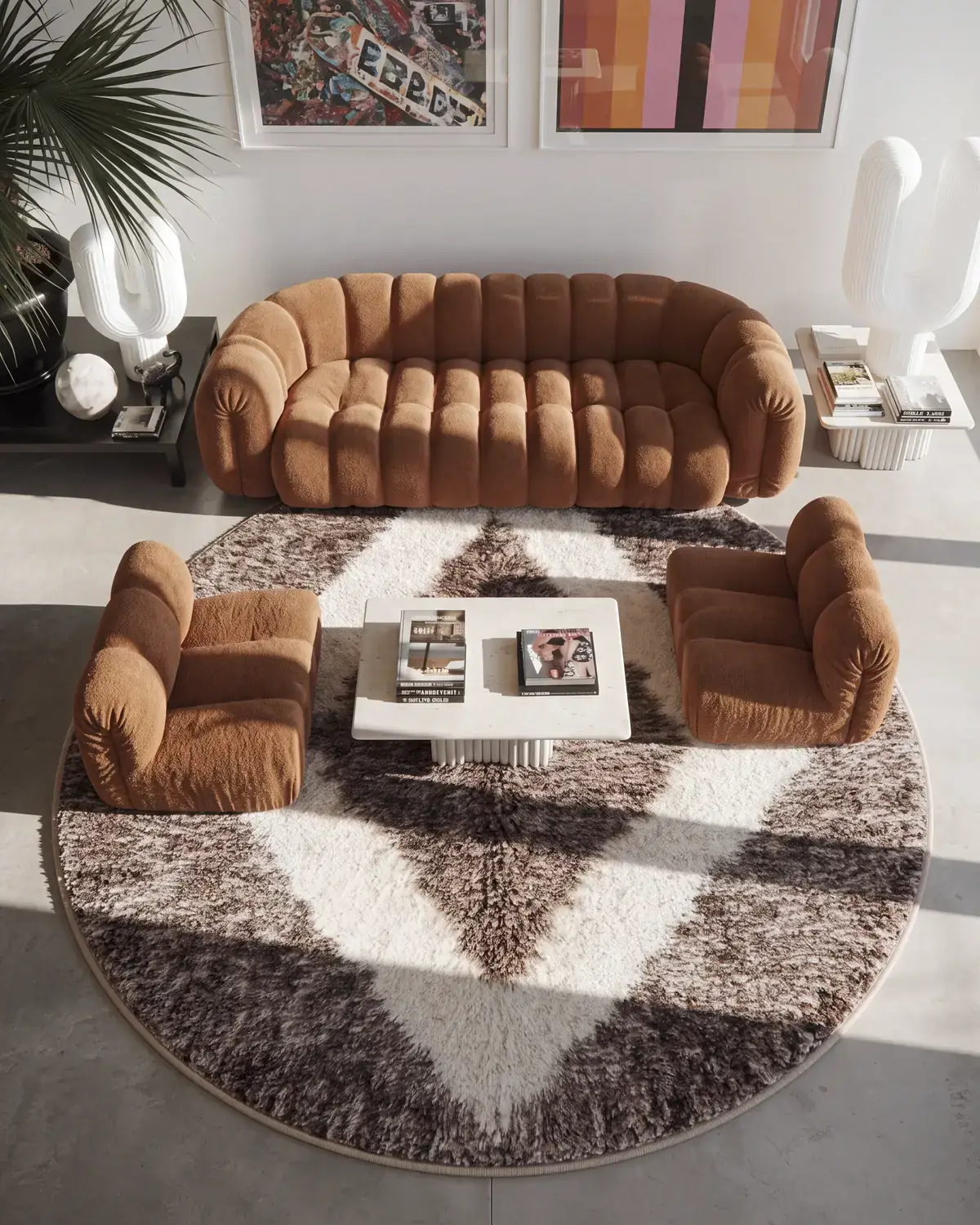 Tamda Taupe & Ivory hand-knotted round Moroccan rug under a camel sofa and two armchairs in a living room