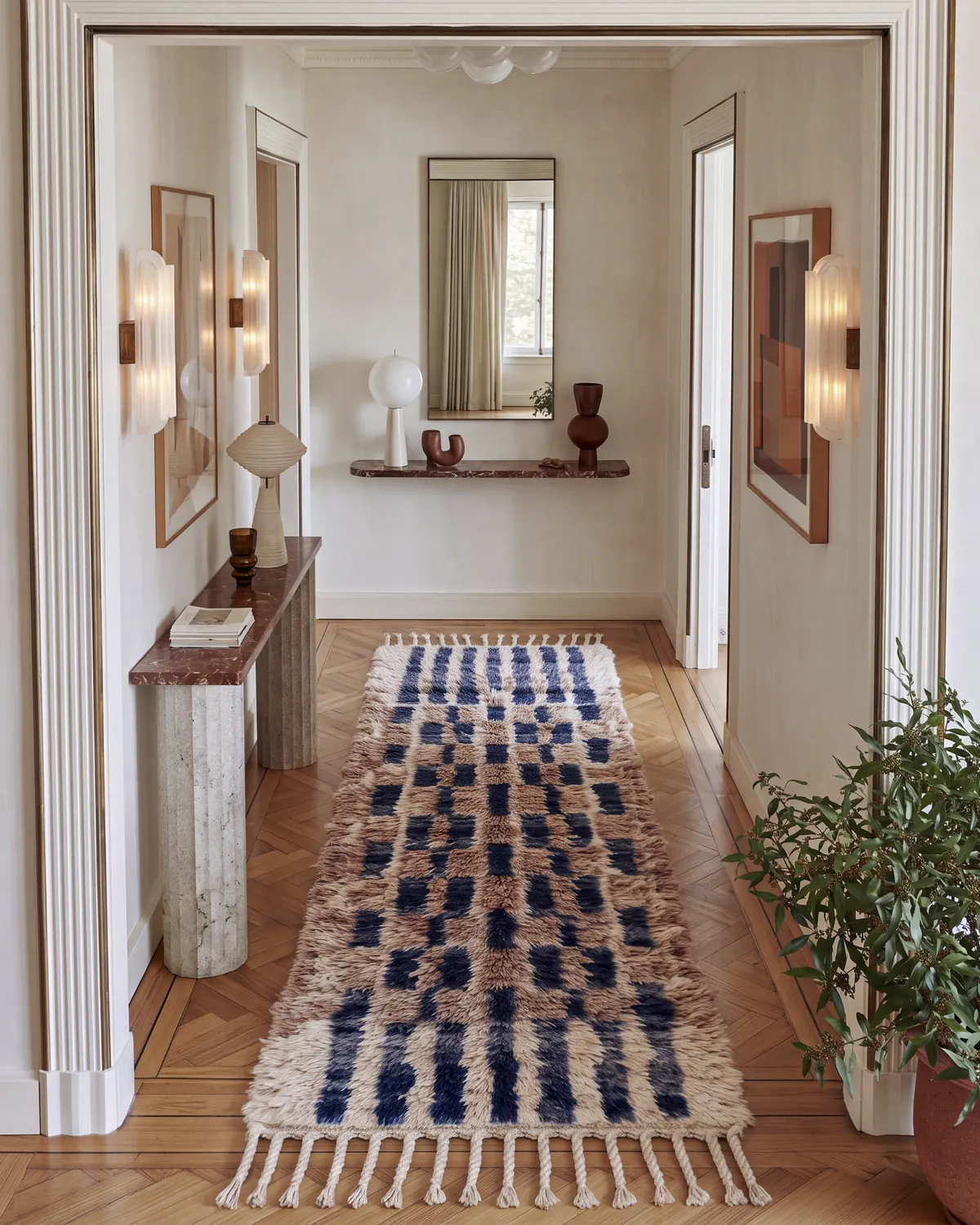 Tirra Navy & Brown hand-knotted Moroccan rug, runner, in a hallway beside a marble console table