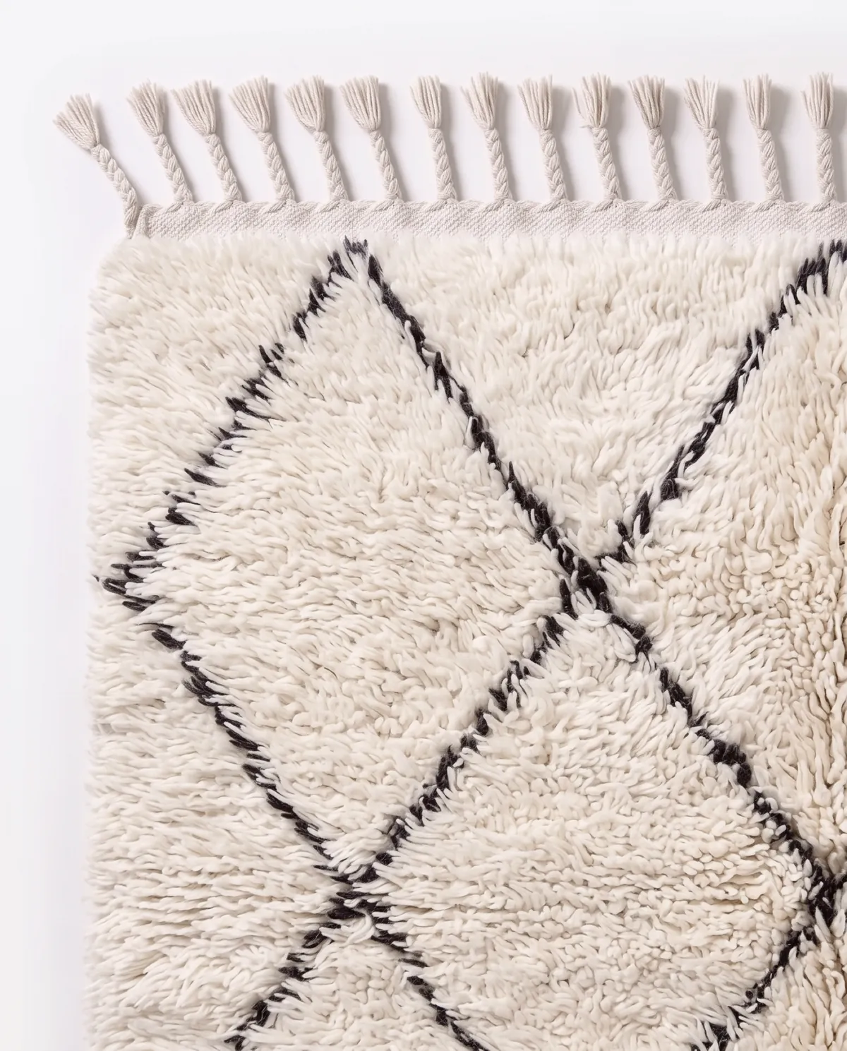 Close view of the pile and pattern of Tichka, an ivory and black hand-knotted rug