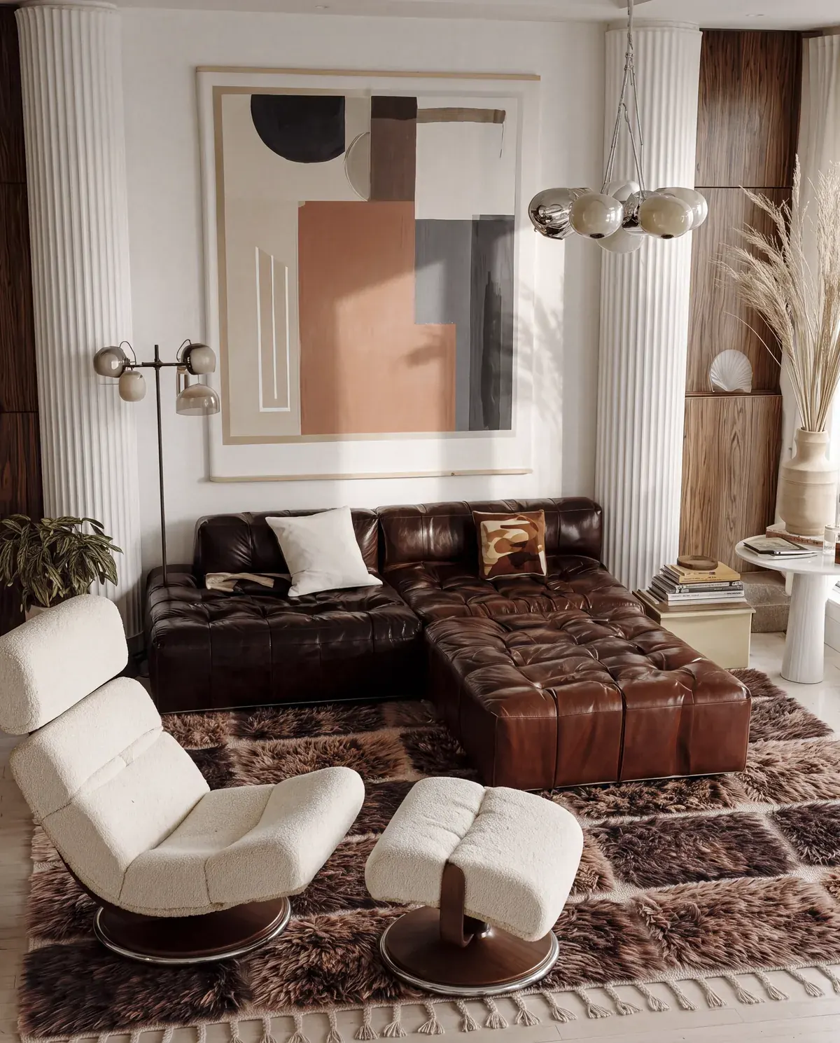 Tadla Chocolate & Brown hand-knotted Beni Mrirt rug under a dark leather sofa and a bouclé lounge chair