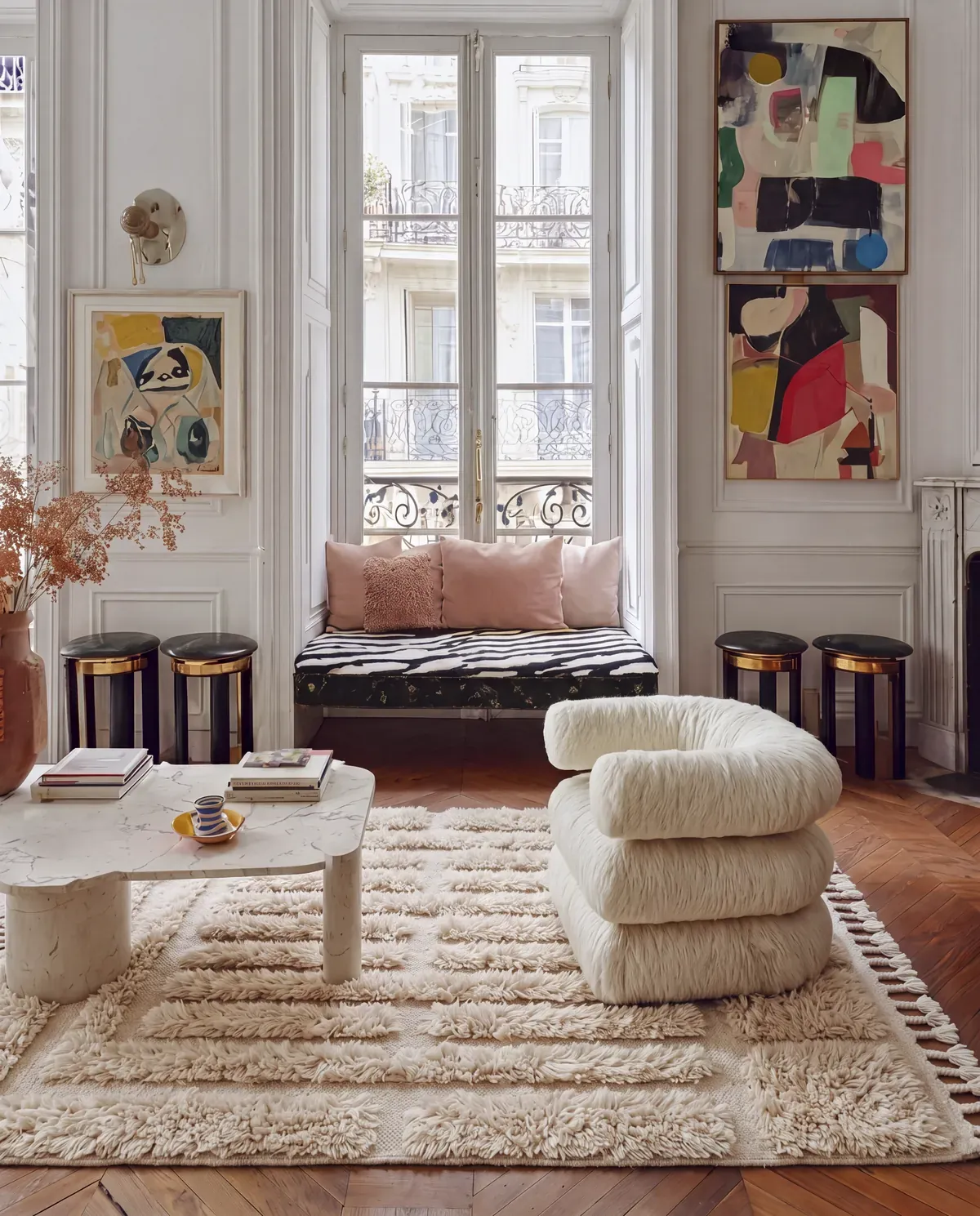 Kasbah Ivory handcrafted Beni Mrirt rug, cream relief bars under a shearling armchair and a marble table