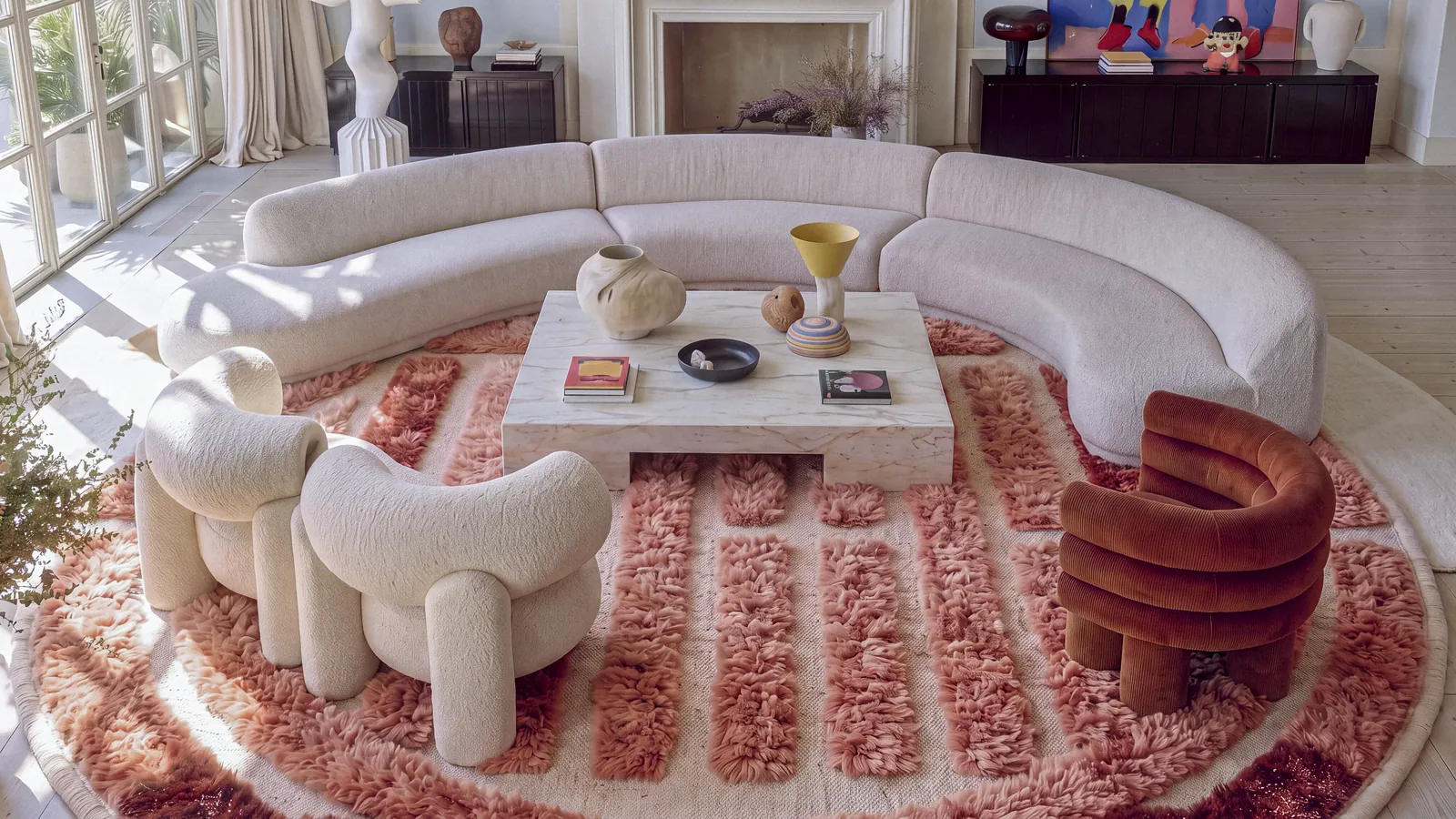 Kasbah Coral & Burgundy round hand-knotted Beni Mrirt rug in a calm living room, sculpted pile in the light