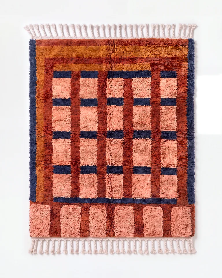 Peach and terracotta windowpane-grid hand-knotted wool rug photographed from overhead